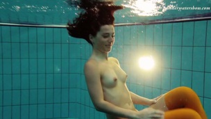 Skinny brunette hair beauty Nina Markova swimming undressed in a pool