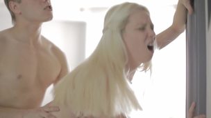 Golden-haired with pale skin is giving a fellatio to her large lover